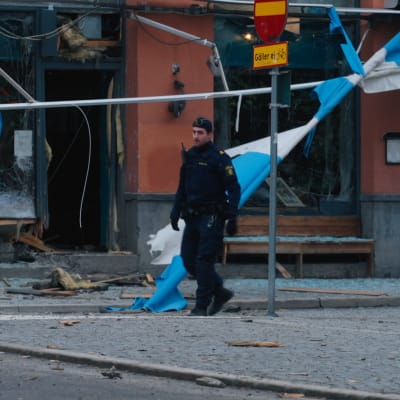 En svensk polis går runt på explosionsplatsen.