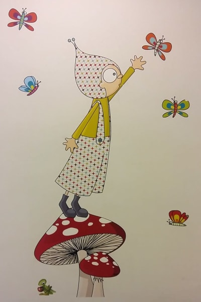 Väggmålning av en flicka som fångar fjärilar.