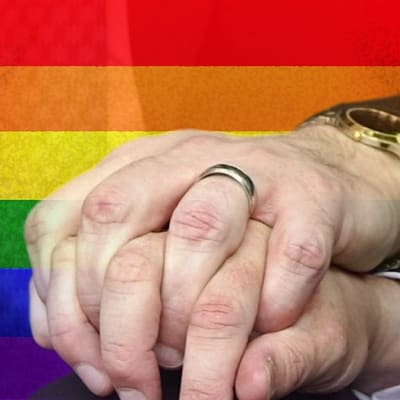 Två homosexuella män håller varandra i handen