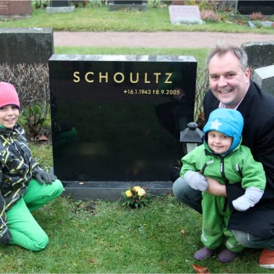 Christer Schoultz med sina barn vid pappas grav
