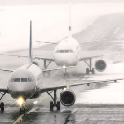 Aeroflotin ja Finnairin koneet lumipyryssä Helsinki-Vantaan lentokentällä.