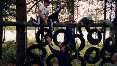 barn i klätterställning av bilringar.