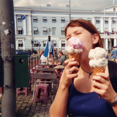 Kvinna äter glass på Salutorget i Helsingfors
