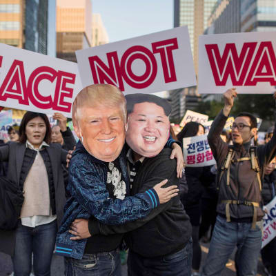 Donald Trump ja Kim Jong-Un -maskeihin pukeutuneet mielenosoittajat halasivat rauhanmarssilla Soulissa 5. marraskuuta.