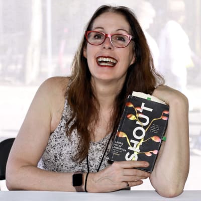 Den amerikanska författaren Laurie Halse Anderson med boken "Shout" i händerna. Fotot taget på en bokmässa i Texas år 2019.