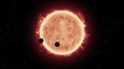 En artists bild av två exoplaneter som kretsar kring en röd dvärg