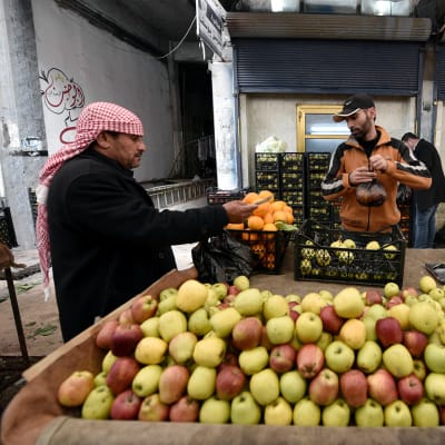 Katukauppias myy omenoita Pohjois-Syyrian kurdialueella Al-Qamishlissa.