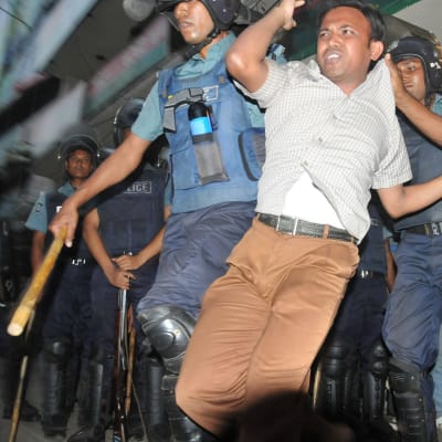 Poliisi pidättä mielenosoittajia Dhakaassa marraskuussa 2013.