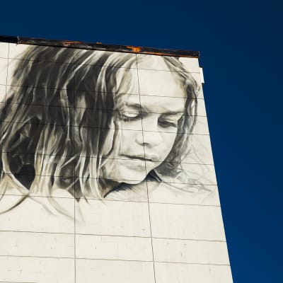 Seinämaalaus kerrostalon seinässä Helsingissä