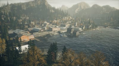 Pieni vuoristokaupunki veden ääressä videopelissä.