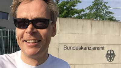 Kaj Arnö ler utanför en statsbyggnad i München