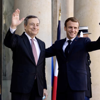 Mario Draghi till vänster och Emmanuel Macron till höger. Bakom Macron skymtar en soldat och den franska flaggan.