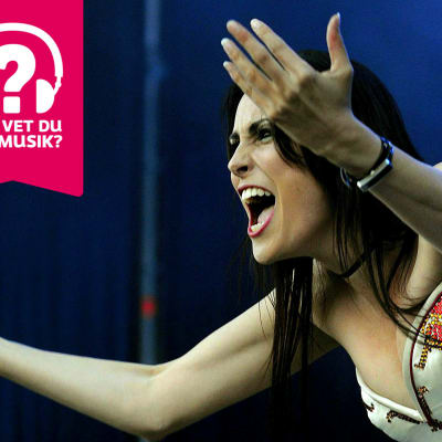 Sångerskan Sharon den Adel från bandet Within Temptation grimaserar och sträcker ut armarna framför sig.