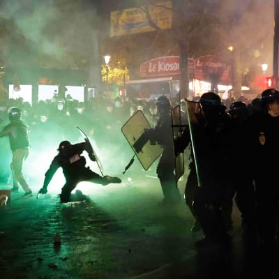 Naamioituneet mielenosoittajat ottavat yhteen poliisin kanssa Pariisissa.