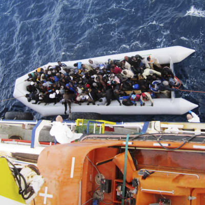 on 20 April 2015 shows a boat with refugees next to the cargo ship 'OOC Cougar' in the Mediterranean sea on 05 February 2015. The ships of the German shipping company Opielok Offshore Carriers have rescued more than 1,500 people in the Mediterranean sea s
