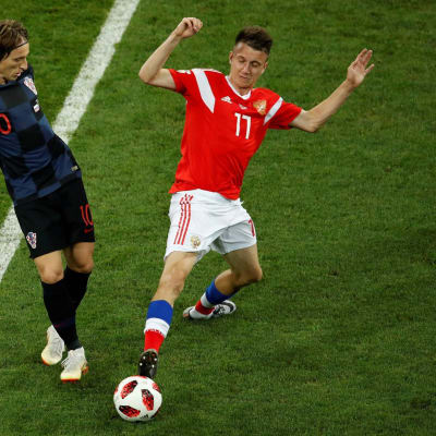 Kroatian Luka Modric (vas.) ja Venäjän Aleksandr Golovin pallon tavoittelussa MM-kisoissa.