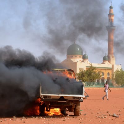 Mielenosoittajien sytyttämä poliisiauto Nigerin pääkaupungissa Niameyssa.