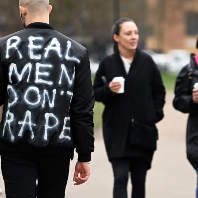 Tosimiehet eivät raiskaa -kirjoitus takin selkämyksessä.
