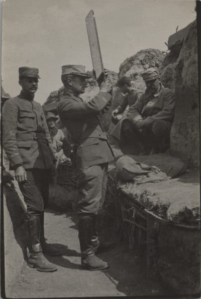 En soldat tittar med ett periskop från skyttegraven under första världskriget.