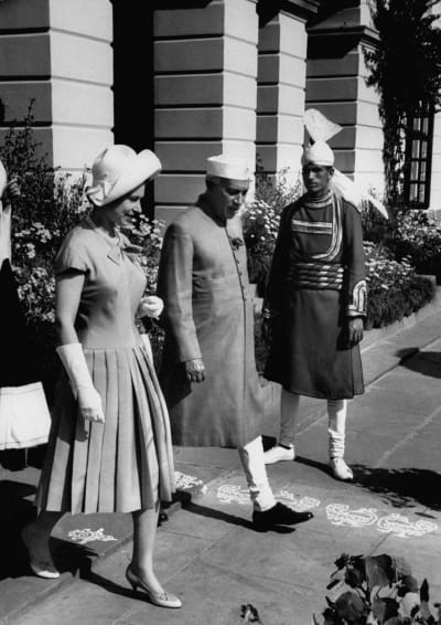 En ung drottning Elizabeth går sida vid sida Jawaharlal Nehru. I bakgrunden syns en 
