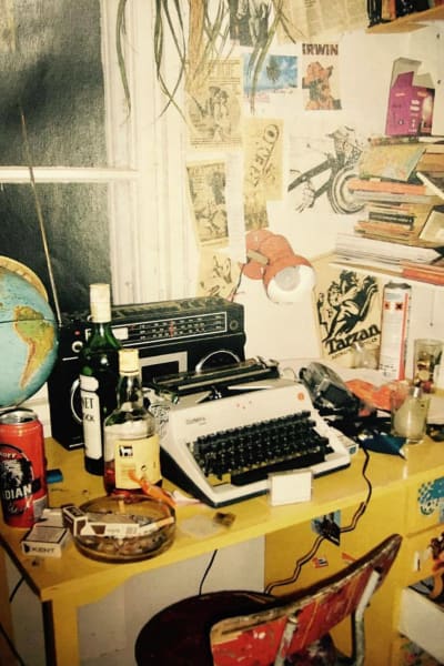 Skrivbord, skrivmaskin, flaskor och fimpar
