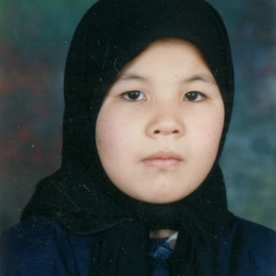 Oikeustulkki Aziza Hossaini pienenä lapsena passikuvassa pukeutuneena huiviin. 