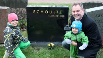 Christer Schoultz med sina barn vid pappas grav