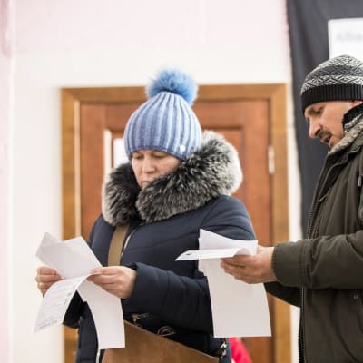 Äänestäjät tutkivat vaalilistoja Chisinaussa Moldovassa sunnuntaina.