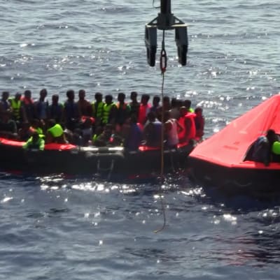 Migranter som räddats efter att en fiskebåt kapsejade utanför Libyens kust.