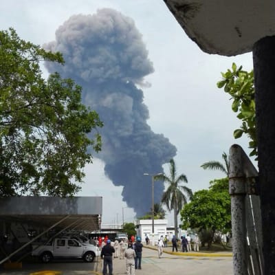 Työntekijät evakuoivat öljy-yhtiö Pemexin rakennuksia voimakkaan räjähdyksen jälkeen Coatzacoalcosin kaupungissa Meksikossa keskiviikkona.