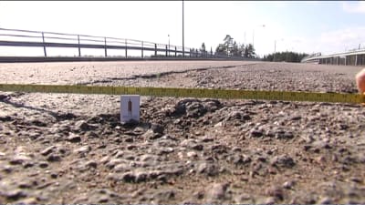 Tändstgicksask i och måttband över grop som har lappats med oljegrus på landsvägen mellan Lappträsk och Lovisa.