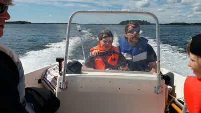 Rasmus Lundén, projektkoordinator vid Icehearts svenskspråkiga verksamhet uten och åker båt med barnen. 