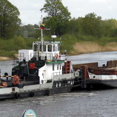 En pråm lastad med Baltikums ny största autotransformator flyter upp för floden Njemen mot Alytus i södra Litauen.