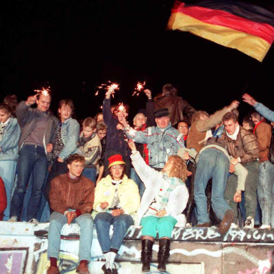 Folk firar vid Berlinmuren.
