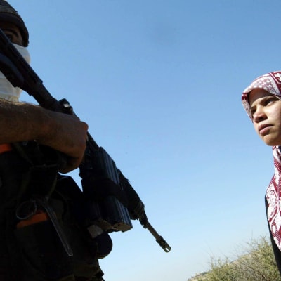 Palestinsk flicka och israelisk soldat i byn Al Zawiya på Västbanken.