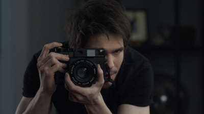 Fotografen Alex riktar kameran mot kameran.