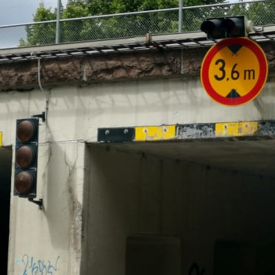 Ajoneuvon maksimikorkeudesta kertova liikennemerkki 3.6 metriä ja varoitusvalot Turun Koulukadun rautatielikulkusillalla.