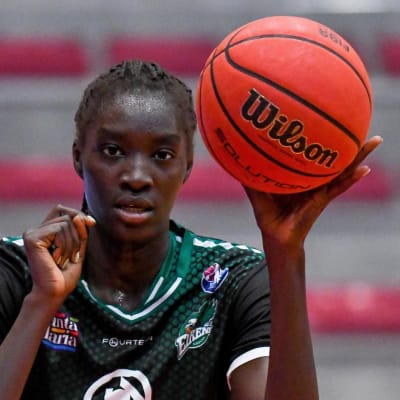 Awak Kuier i mörkgrön spelblus med basketbollen i vänster hand.