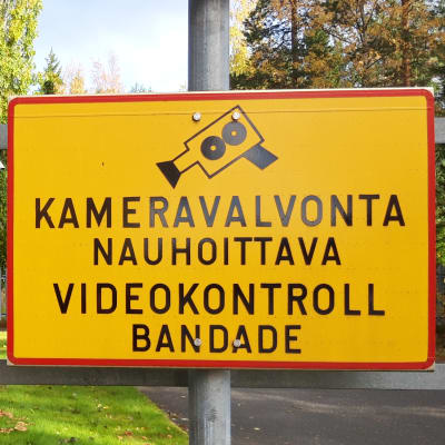 Skylt om övervakningskamera vid Polishuset i Karleby. Texten på skylten lyder: Kameravalvonta nauhoittava videokontroll bandande. 