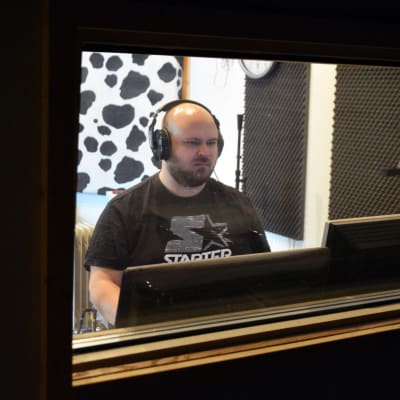 Petri Nakkila istumassa äänitysstudiossaan.