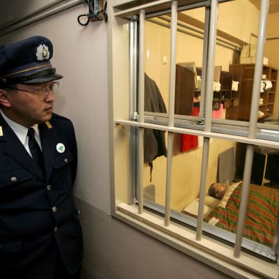 En japansk fångvaktare tittar in i en cell i ett fängelse i Toyama, i centrala Japan. Bilden är en arkivbild från 2006.