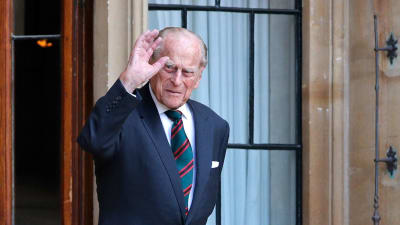 Prins Philip vinkar när han går ut genom en dörr. Bilden tagen i juli 2020.