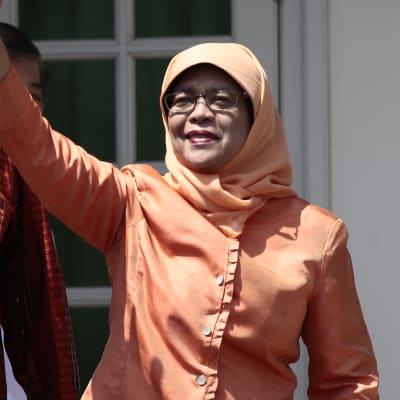 Singapores nyvalda president hälsar på folket tillsammans med sin man.