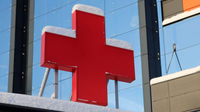 Stort rött, snötäckt kors vid vid en ingång till Vasa centralsjukhus. 