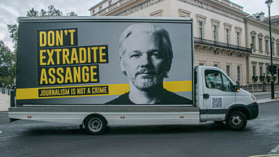 "Utlämna inte Assange" står det på bussen. 