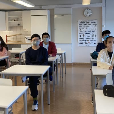 Suomeen lukiokoulutukseen tulleet vietnamilaiset istuvat luokkahuoneessa Sallan lukiossa