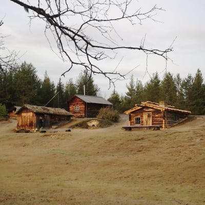 Hiekkarinteessä sijaitsevat Raja-Joosepin rakennukset. Taustalla havumetsää pilvisenä syksyisenä päivänä.