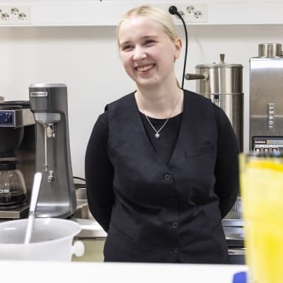 Nainen seisoo ammattioppilaitoksen keittiössä.