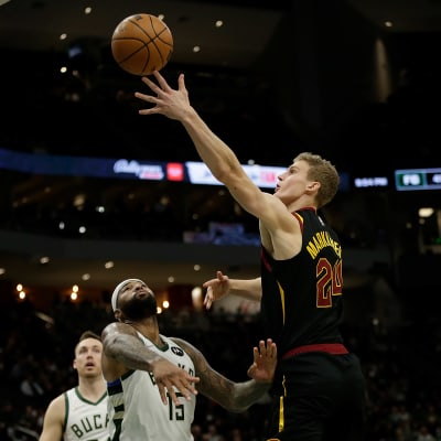 Lauri Markkanen heittää pallon kohti koria. 