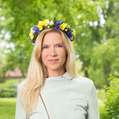 Författare Liza Marklund med blomsterkrans i håret.
